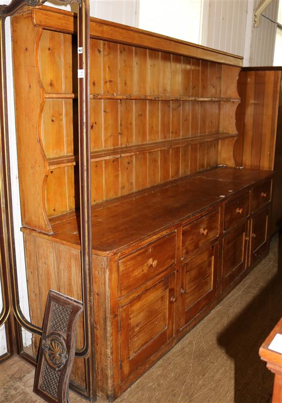 A large stripped pine kitchen dresser